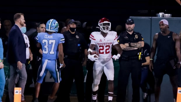 Oct 7, 2021; New Orleans, Louisiana, USA; Houston Cougars running back Alton McCaskill (22) reacts to scoring a touchdown against Tulane Green Wave safety Macon Clark (37) during the second half at Yulman Stadium. Mandatory Credit: Stephen Lew-USA TODAY Sports